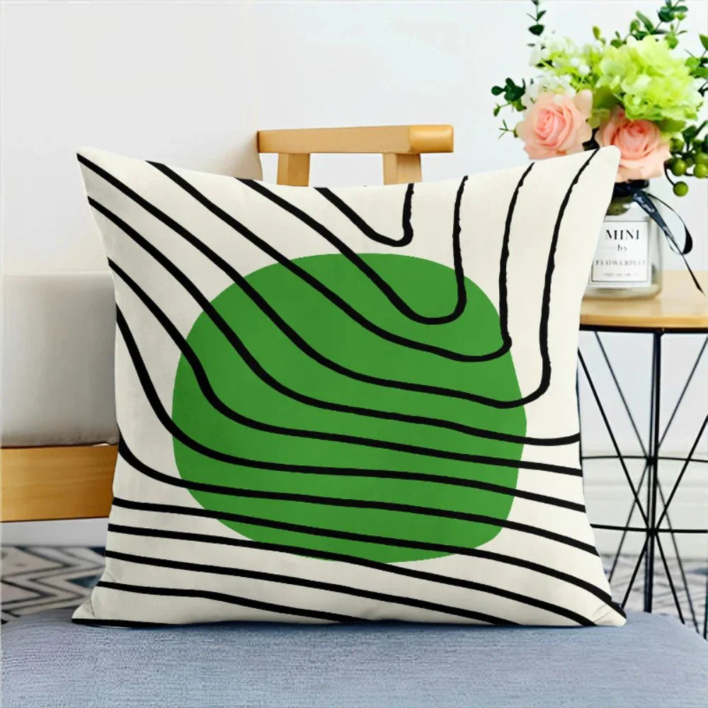 Green nature print pillowcase with abstract design on a chair, featuring soft sage tones.