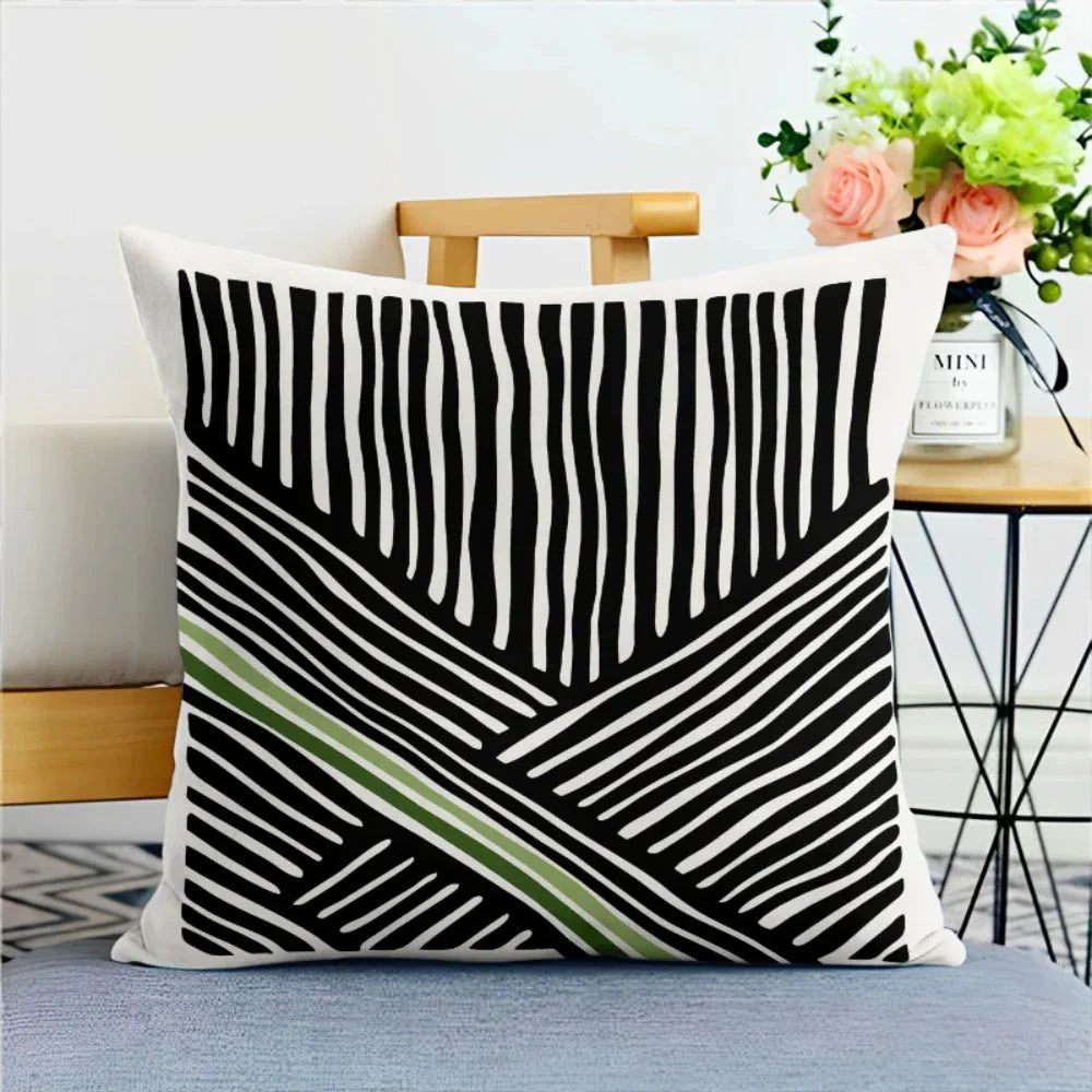 Green nature print LIVIA™ pillowcase with abstract lines on a chair.