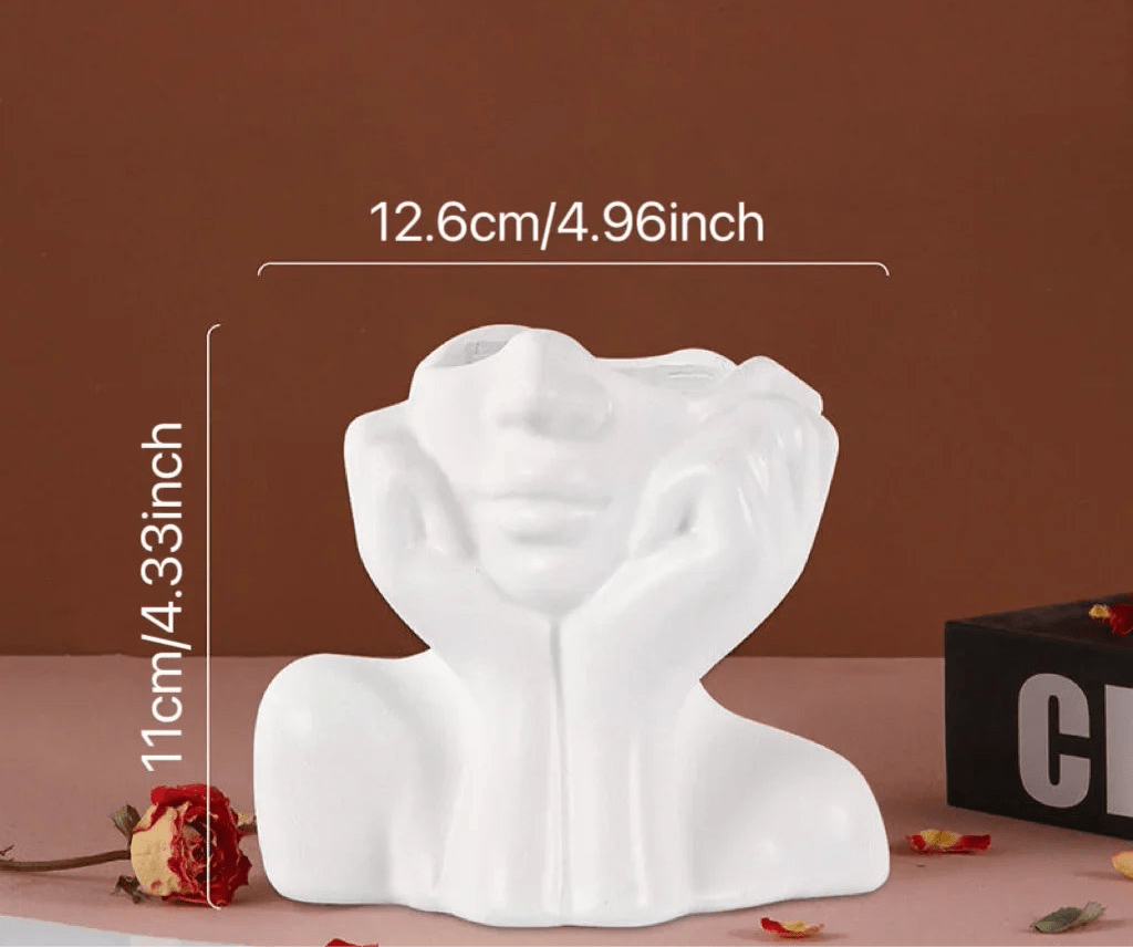 Sculptural white ceramic vase with face design, 12.6cm by 11cm, decorative centerpiece.