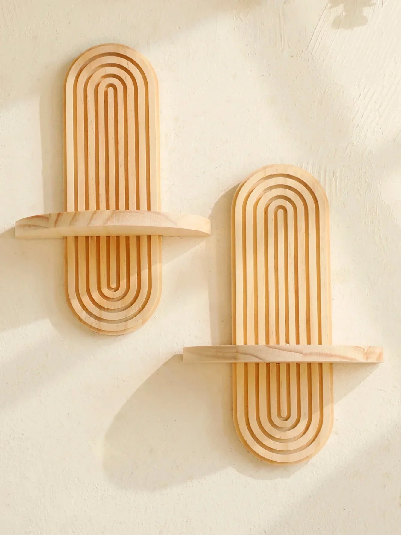 Geometric wooden wall shelves with natural finish, ideal for modern boho decor.