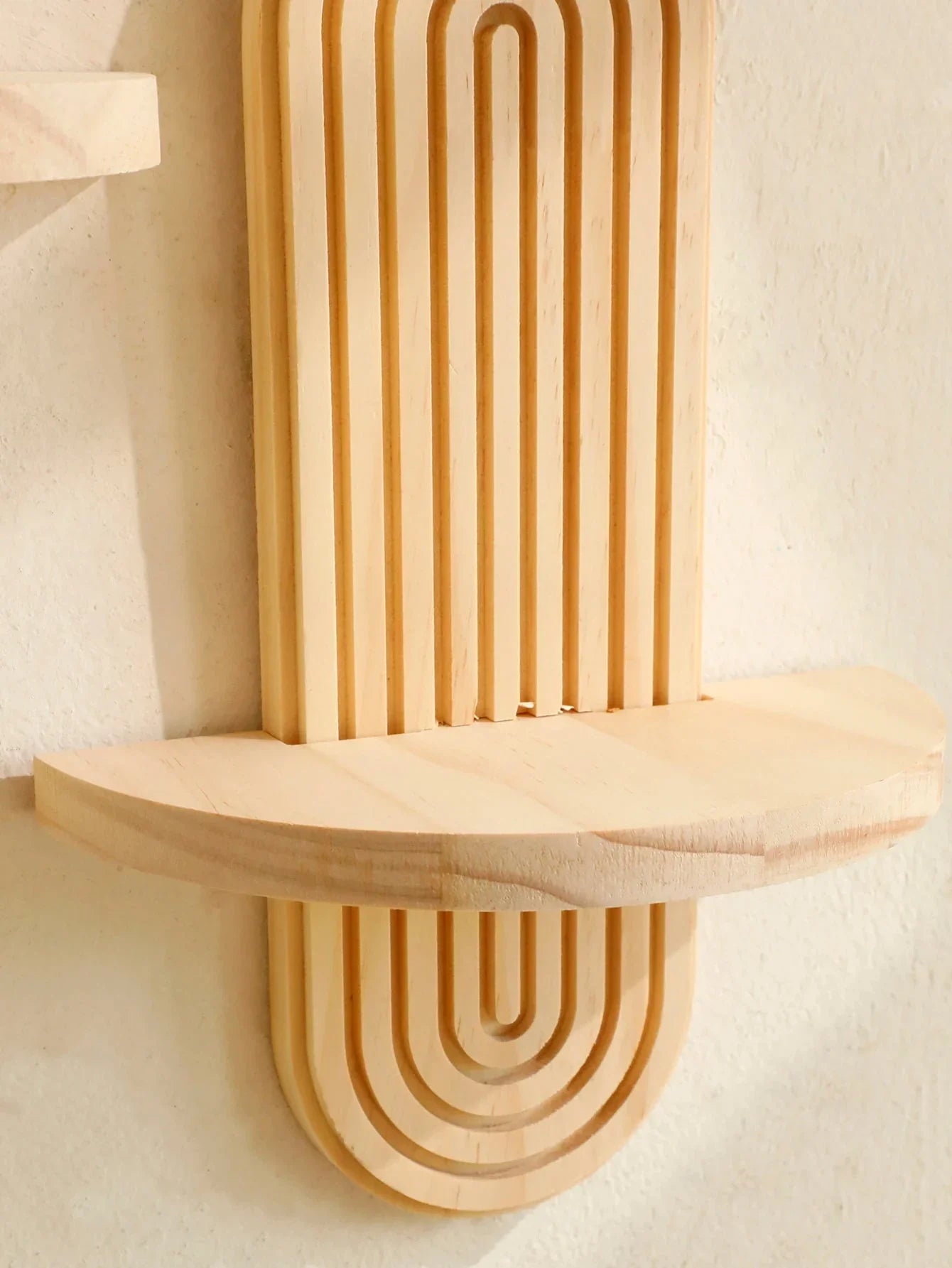 Boho-style natural wood oval wall shelves with geometric design for versatile home decor.