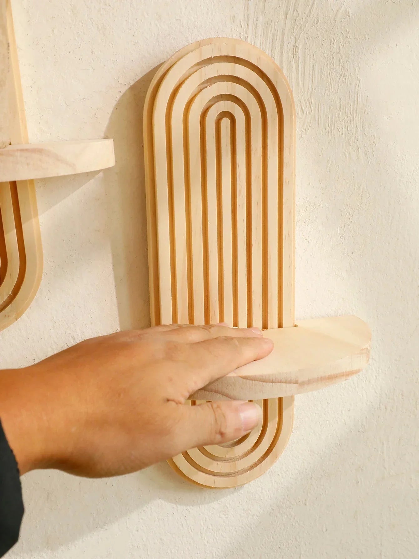 Oval wooden wall shelves being assembled, showcasing natural finish and boho style design for versatile home decor.