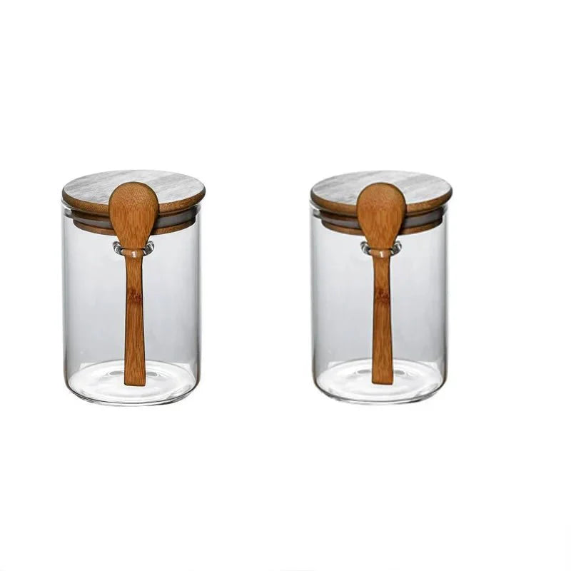 Airtight glass spice jars with bamboo lids and wooden spoons for spice storage.