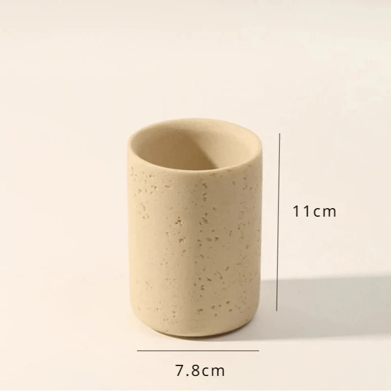 Stone effect toothbrush holder, 11cm tall, beige, cylindrical.