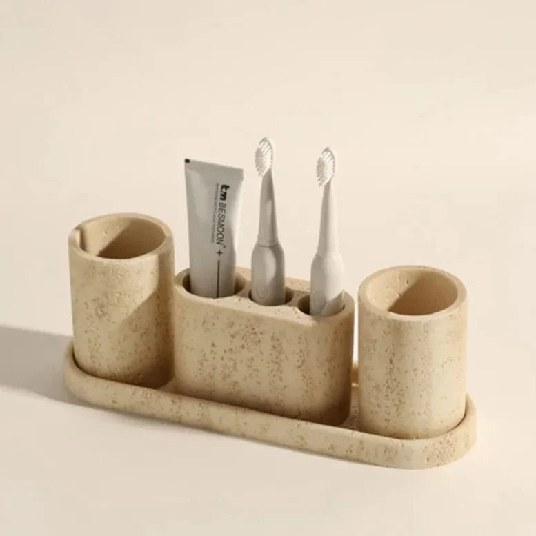 Stone effect bathroom organizer with cylindrical containers holding toothbrushes and toothpaste, crafted for essential storage.