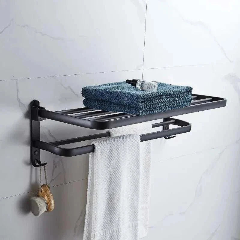 Wall-mounted towel rack with industrial iron design, featuring a matte black finish and dual storage levels for folded towels and hanging options.