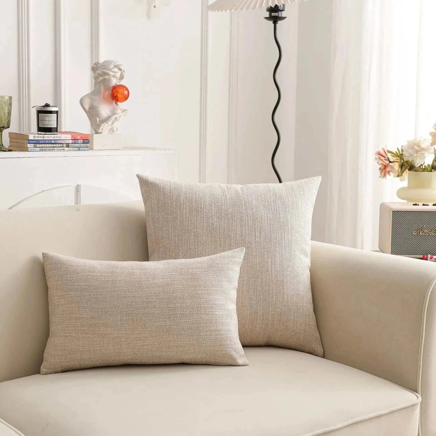 Natural linen pillow covers on sofa, enhancing room with soft, earthy tones; perfect for creating a serene atmosphere. Focus keyword: throw pillow cover.