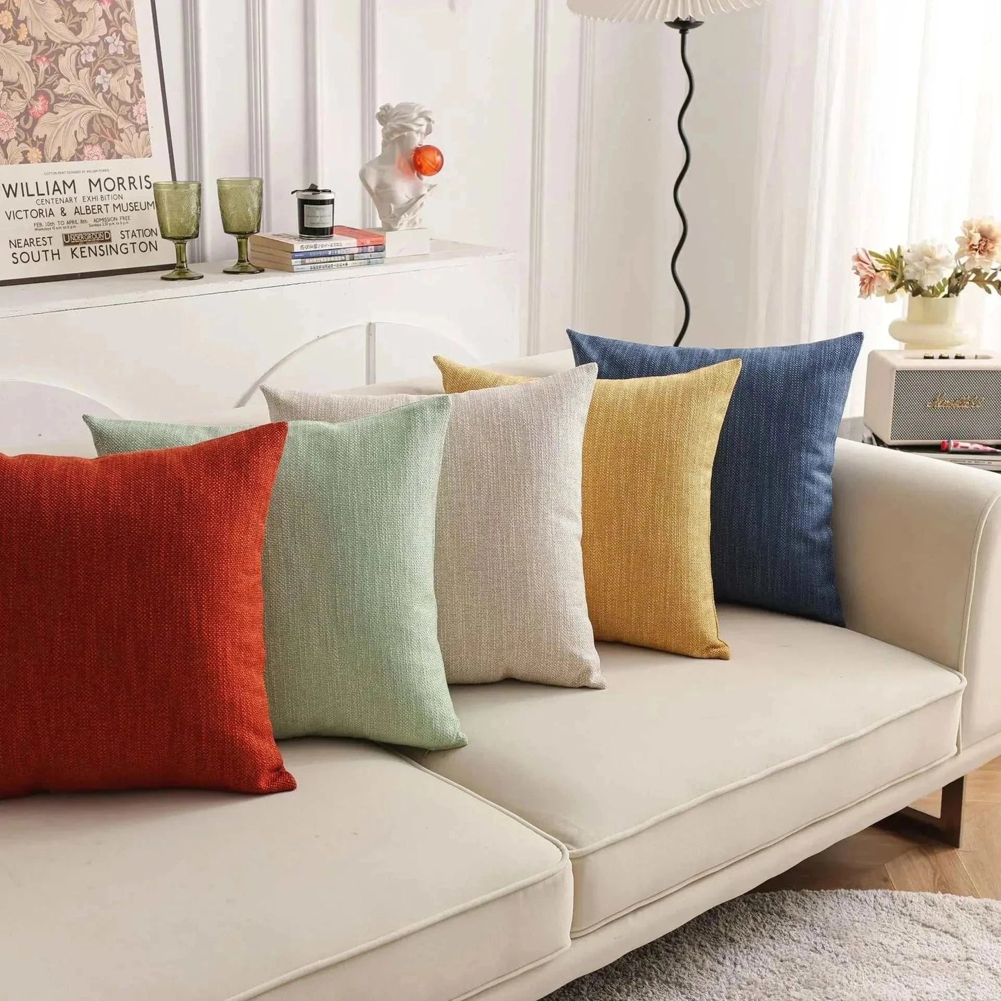 Natural linen throw pillow covers on a sofa in assorted colors.