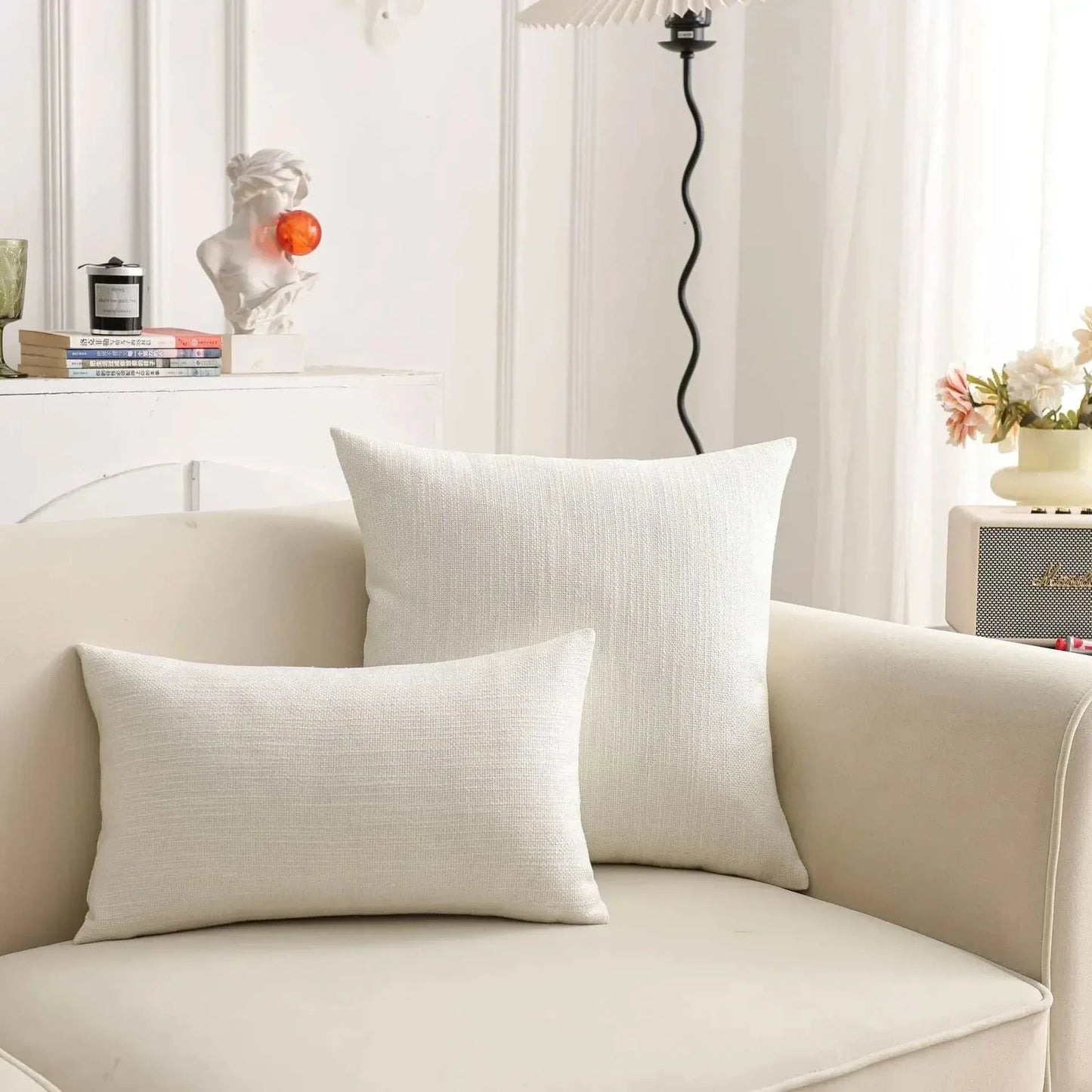 Natural linen throw pillow cover on a sofa, featuring a calm aesthetic and tactile comfort.