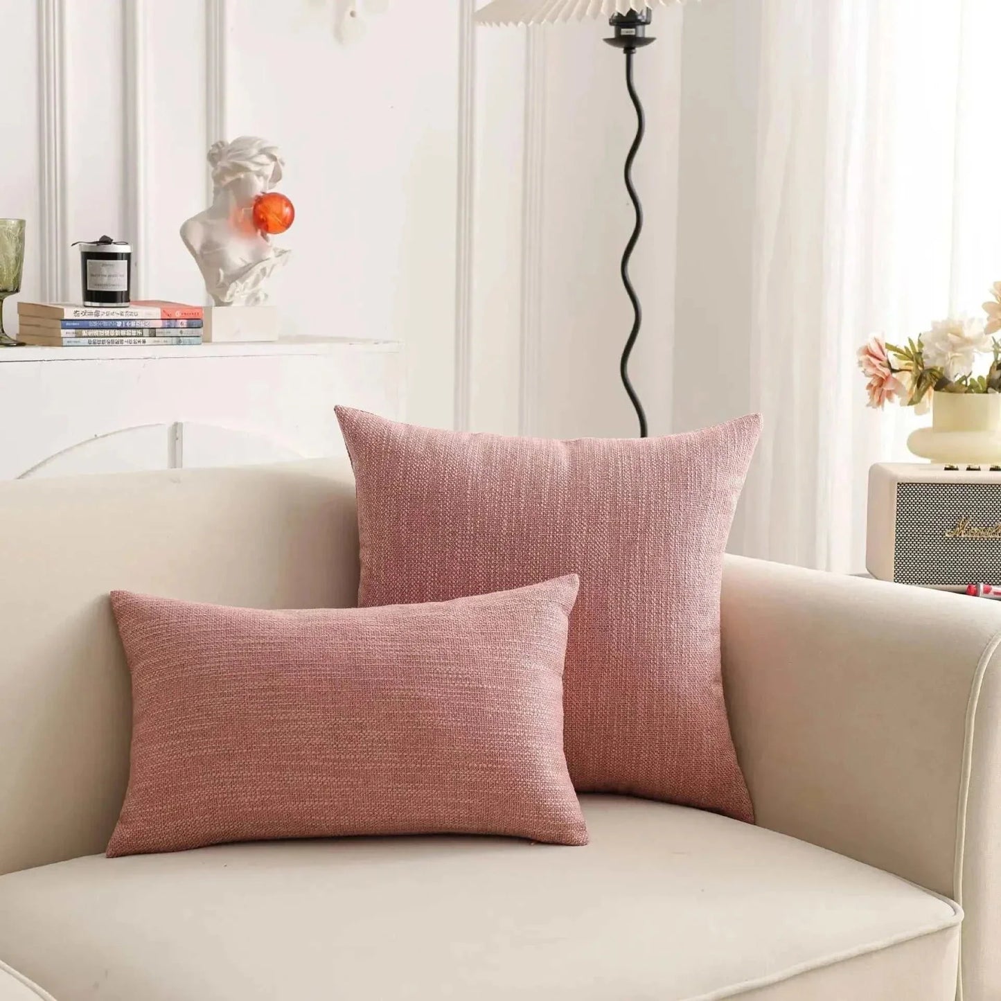 Natural linen throw pillow covers on a sofa in a cozy living room setting.