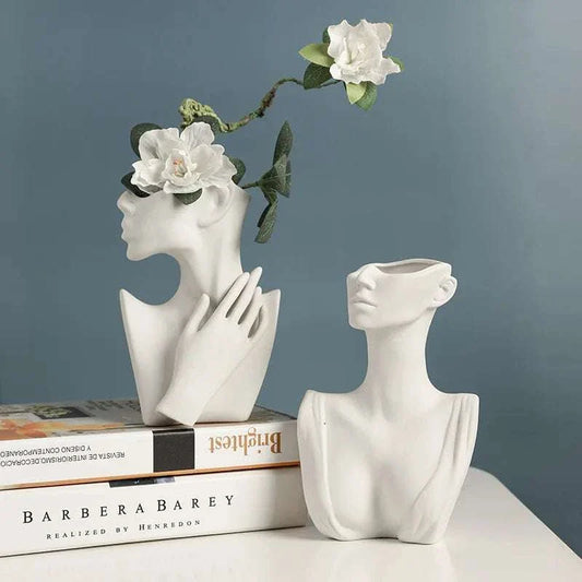 Artistic ceramic vase with human silhouette on display.
