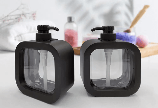 Modern matte black soap dispensers set on a countertop with a contemporary design, ideal for kitchen and bathroom use.