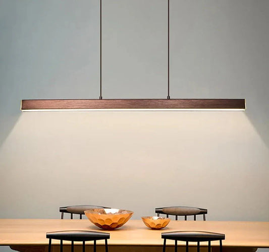 Minimalist suspended LED pendant light above a kitchen table.