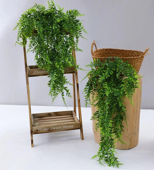 Lush faux hanging fern for indoor decor in wooden planter display.