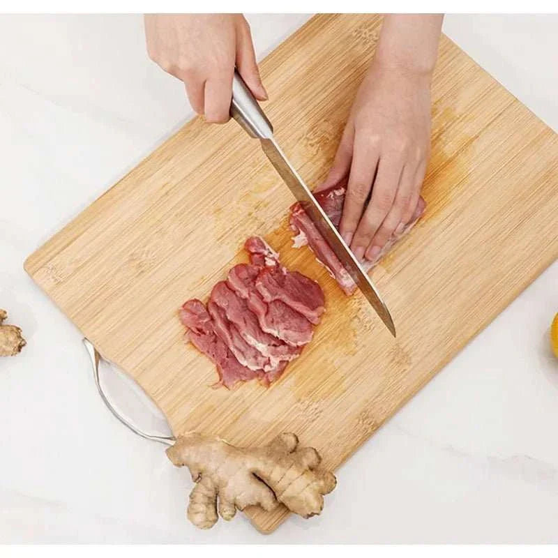Natural bamboo cutting board with handle, showcasing durability and eco-friendly design, perfect for kitchen use.