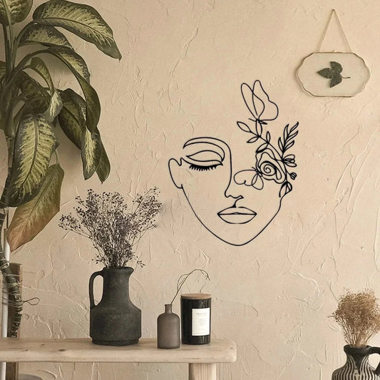 Botanical wall art featuring a feminine profile in black metal wire, enhancing modern interiors.