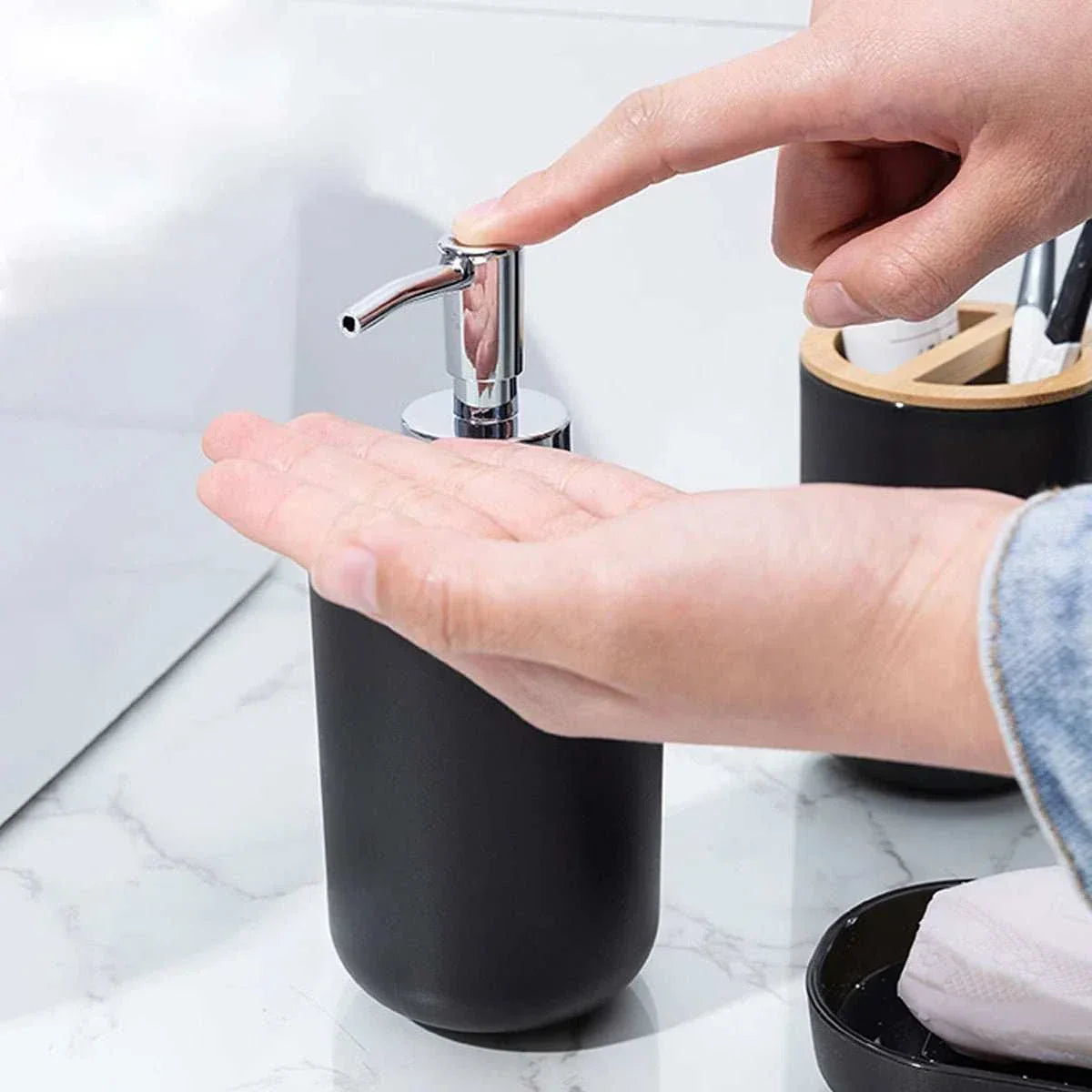 Matte ceramic soap dispenser with pump, part of BICCHIO bathroom set, shown on a marble countertop.