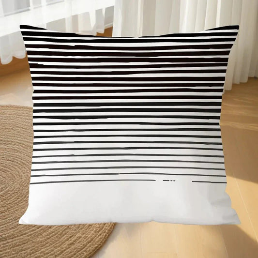 Black and white geometric MIRA™ pillowcase on a couch, ideal for modern decor.