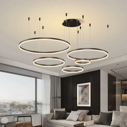 Modern LED pendant light fixture with circular design in a stylish living room.