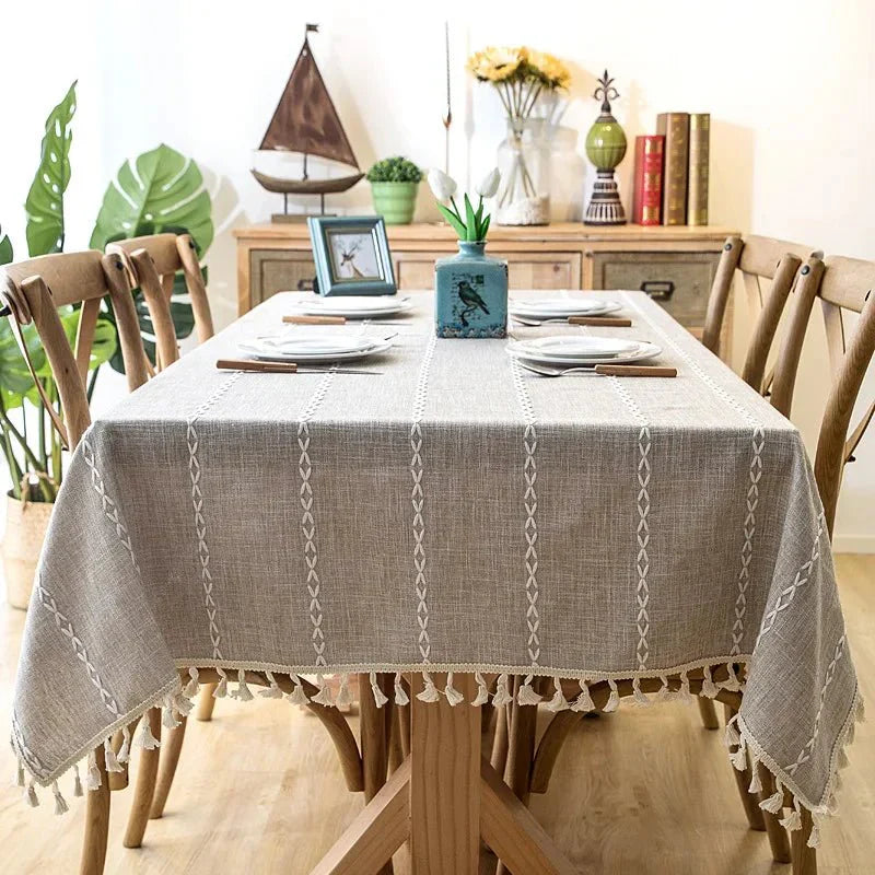 Elegant CENTRARIN™ tablecloth on dining table with chairs, featuring soft linen-feel fabric and tassel edges for a natural, sophisticated look.