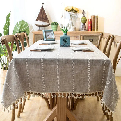 Elegant CENTRARIN™ tablecloth on dining table with chairs, featuring soft linen-feel fabric and tassel edges for a natural, sophisticated look.