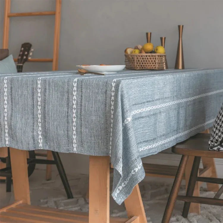 Soft linen-feel tablecloth with a subtle woven pattern and tassel edge for everyday use.