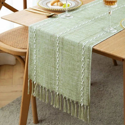 Woven natural cotton table runner with rustic macrame design on dining table.
