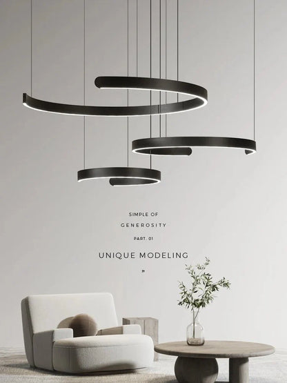 Minimalist geometric LED pendant light in modern style, featuring black and white semicircular rings, enhances ceiling aesthetics.