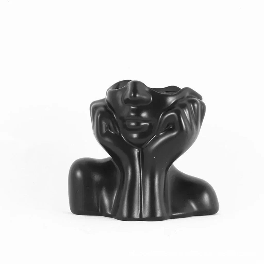 Matte black sculptural ceramic vase with a thoughtful face design, FIOR™.
