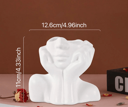 Sculptural white ceramic vase with face design, 12.6cm by 11cm, decorative centerpiece.