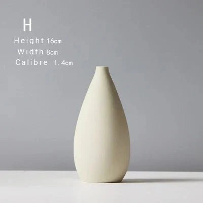 Sculptural ceramic vase with matte finish, slender design, 16cm tall, 8cm wide, ideal for decorative use.