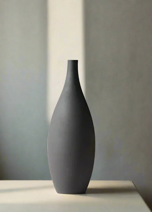 Sculptural ceramic vase with matte finish and tapered silhouette.