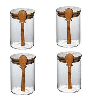 Airtight glass spice storage jars with bamboo lids and spoons.