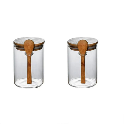 Airtight glass spice jars with bamboo lids and wooden spoons for spice storage.