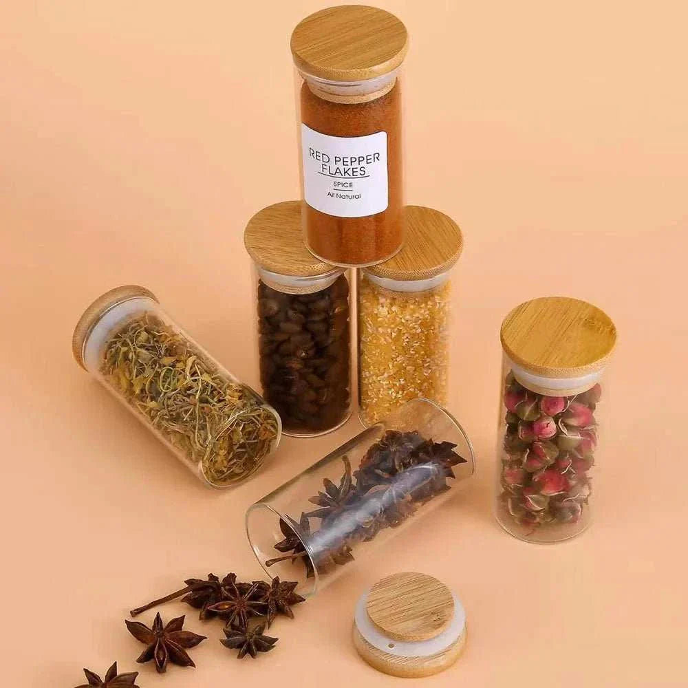 Glass spice jars with bamboo lids, showing various spices and herbs, airtight seal for freshness.