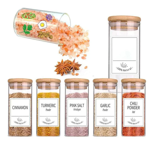 Glass spice jars with bamboo lids filled with spices and pink salt, showcasing airtight storage for kitchen use.