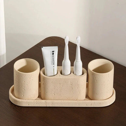 Stone effect bathroom organizer with toothbrush holders and tray.