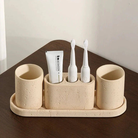 Stone effect bathroom organizer with toothbrush holders and tray.