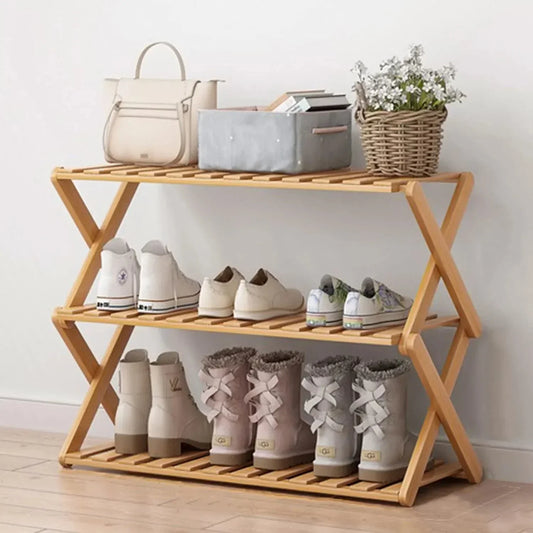 2-tier bamboo shoe rack with slatted design, displaying various types of shoes and accessories in an entryway.