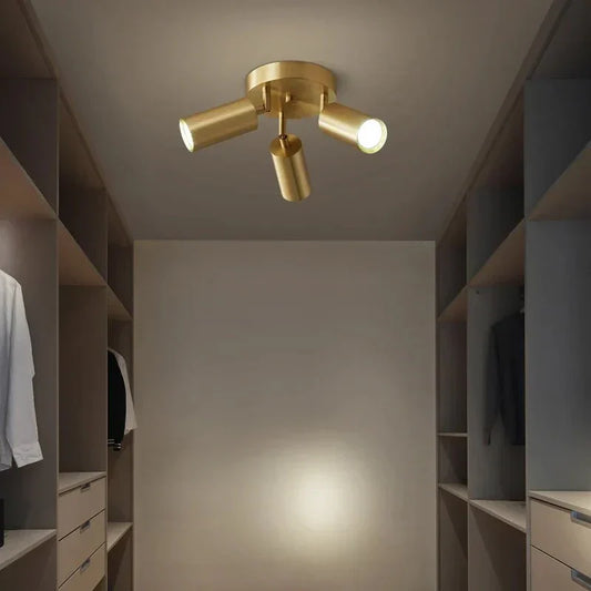 Adjustable LED ceiling light with multiple heads illuminating a modern room.
