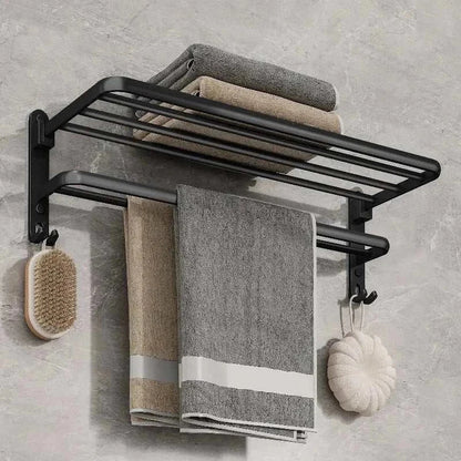 Wall-mounted matte black towel rack with upper shelf and hooks, featuring towels and accessories.