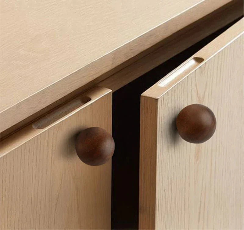 Minimalist natural wood knobs on cabinet drawers.