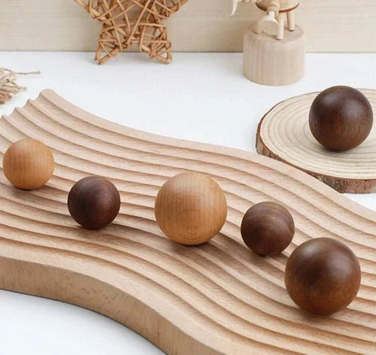 Minimalist wooden knobs in natural beech and walnut on textured surface.