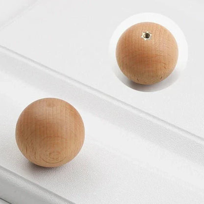 Minimalist wood knob made from natural beech or walnut, ideal for cabinets and drawers.