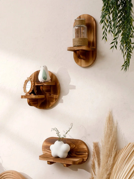Oval floating wall shelves set in natural wood, showcasing decorative items against a serene backdrop.