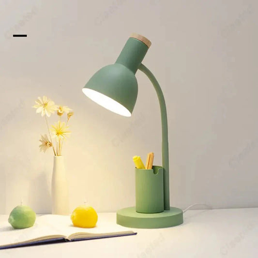 Adjustable desk lamp in pastel green with a built-in pen holder, ideal for study and workspaces.