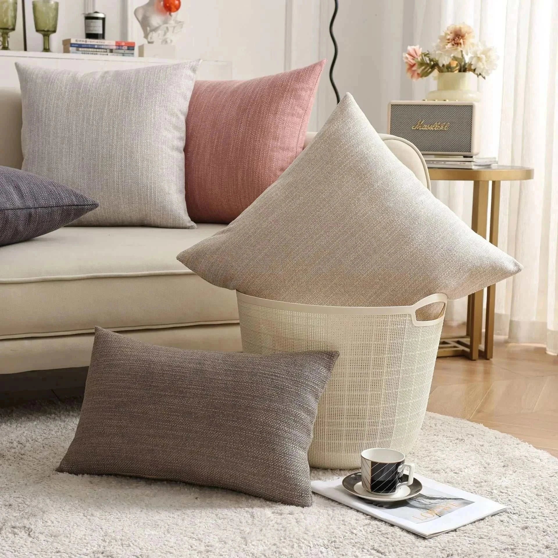 Natural linen throw pillow covers on a sofa with a cozy, modern interior setting.