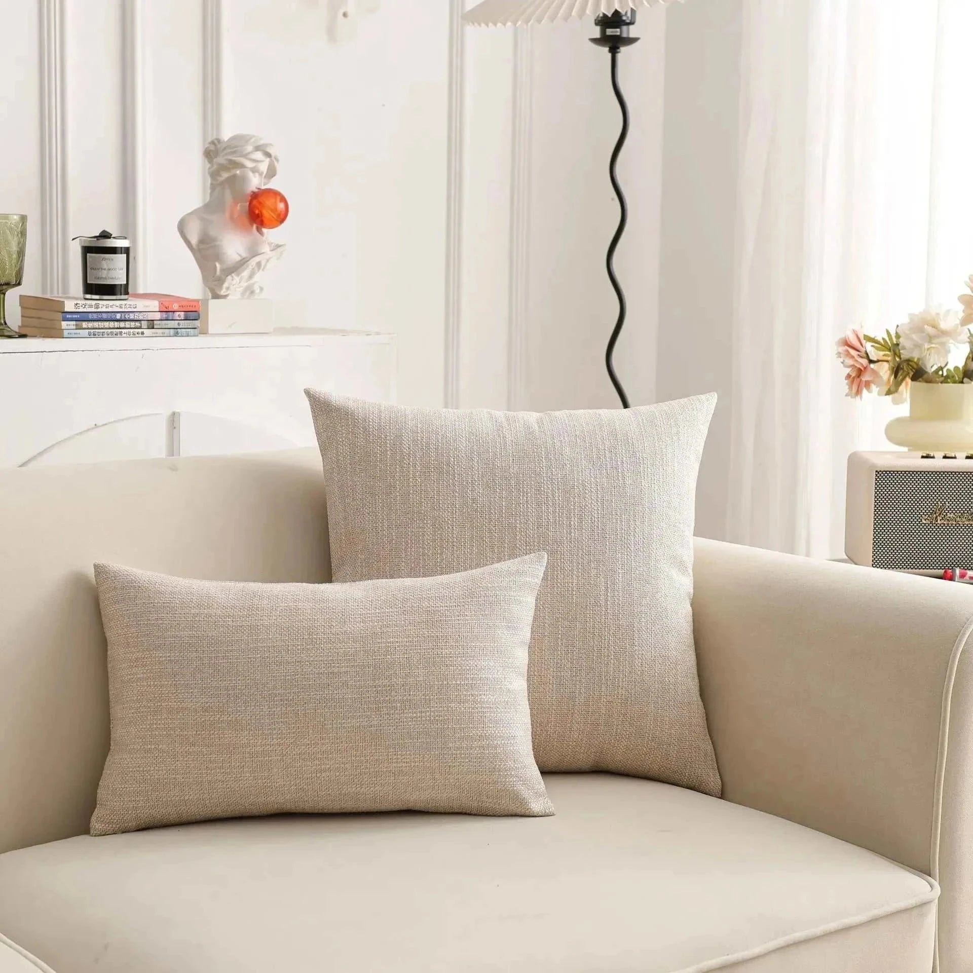 Natural linen pillow covers on sofa, enhancing room with soft, earthy tones; perfect for creating a serene atmosphere. Focus keyword: throw pillow cover.