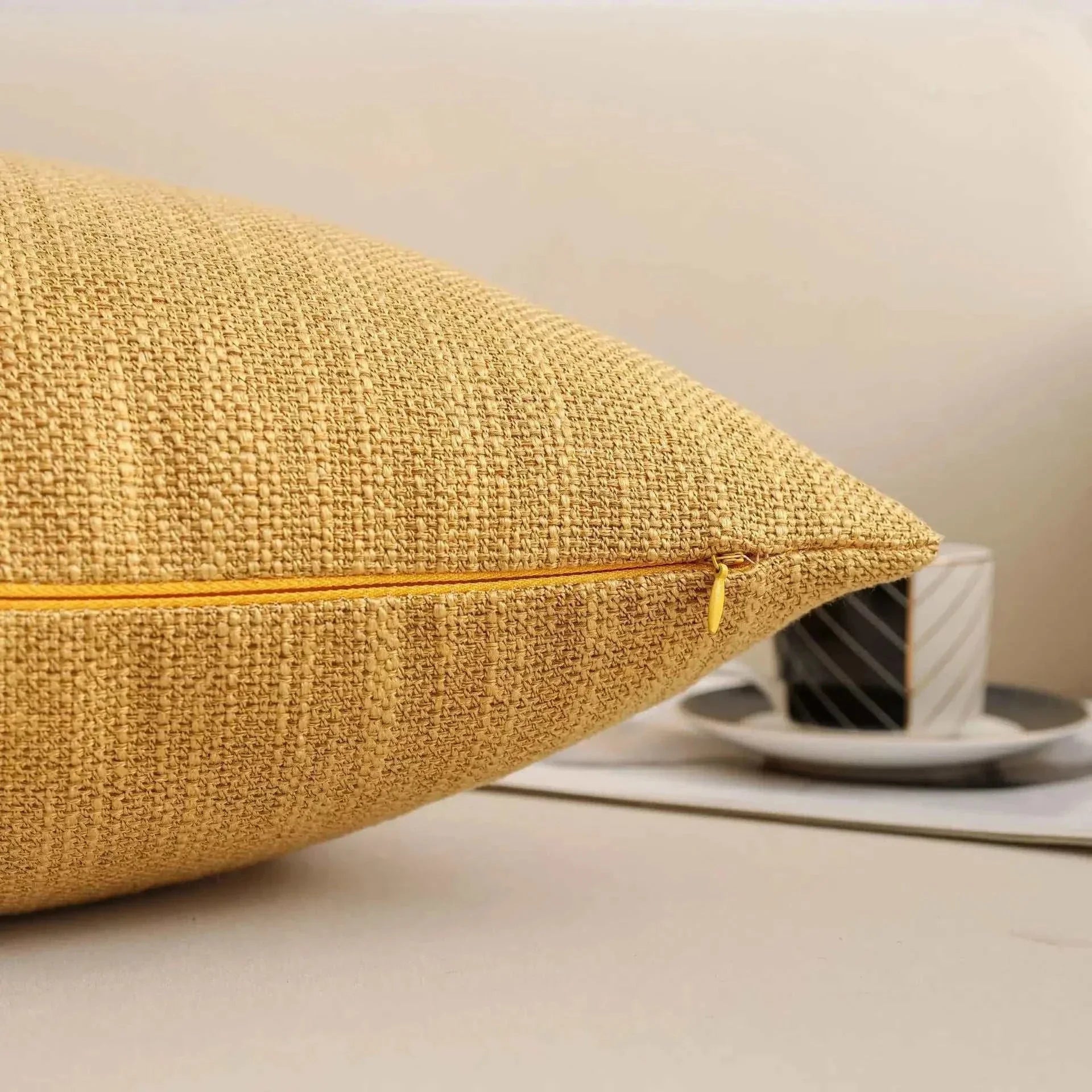 Natural linen throw pillow cover with visible weave texture and hidden metal zipper closure.