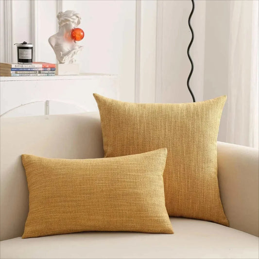 Natural linen throw pillow cover in a warm, textured design, displayed on a sofa for a cozy, timeless look.